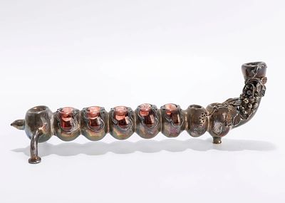 A SILVER OVERLAY HANUKKAH LAMP. Israel, modern. Made of light silver on glass. 10 inches wide.