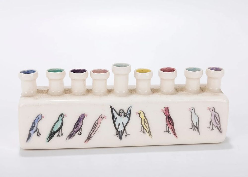 A CERAMIC HANUKKAH LAMP BY POMERANTZ. Jerusalem, c. 1990. Hand painted with birds. 7 inches wide.