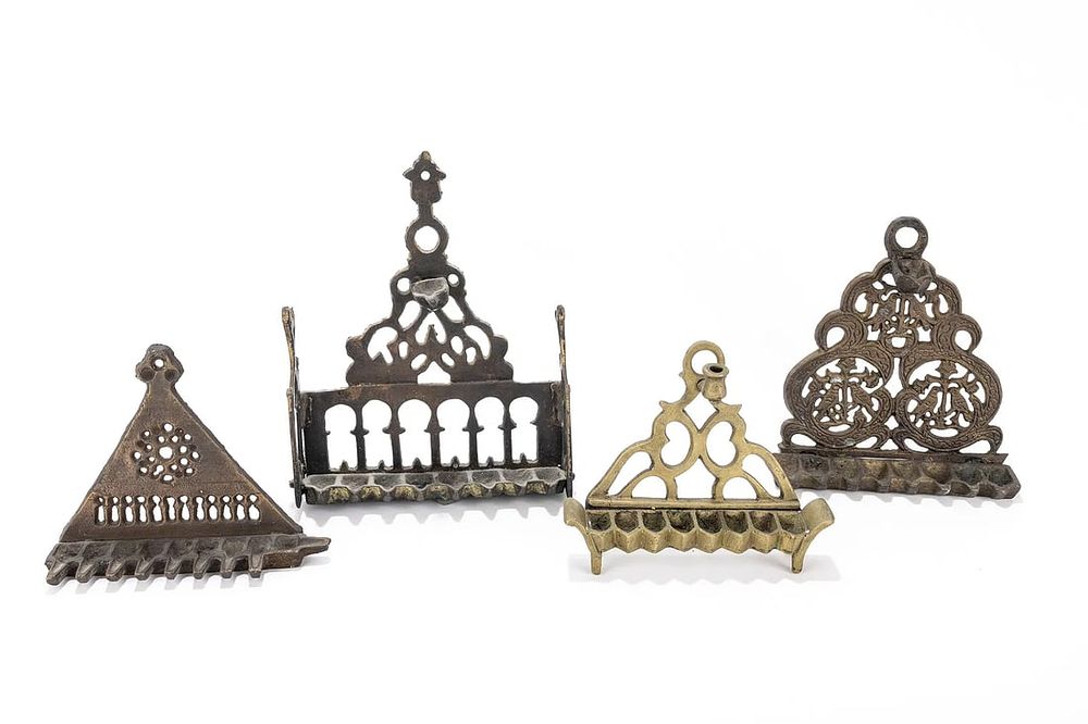 A GROUP OF FOUR HANUKKAH LAMPS. Probably Israel, modern. Each one of a different cast brass 