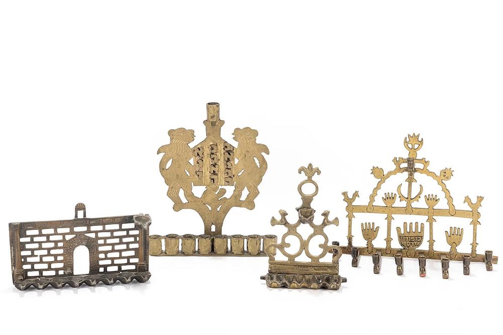 A GROUP OF FOUR BRASS HANUKKAH LAMPS. Probably Israel. Each one of a different design. The 