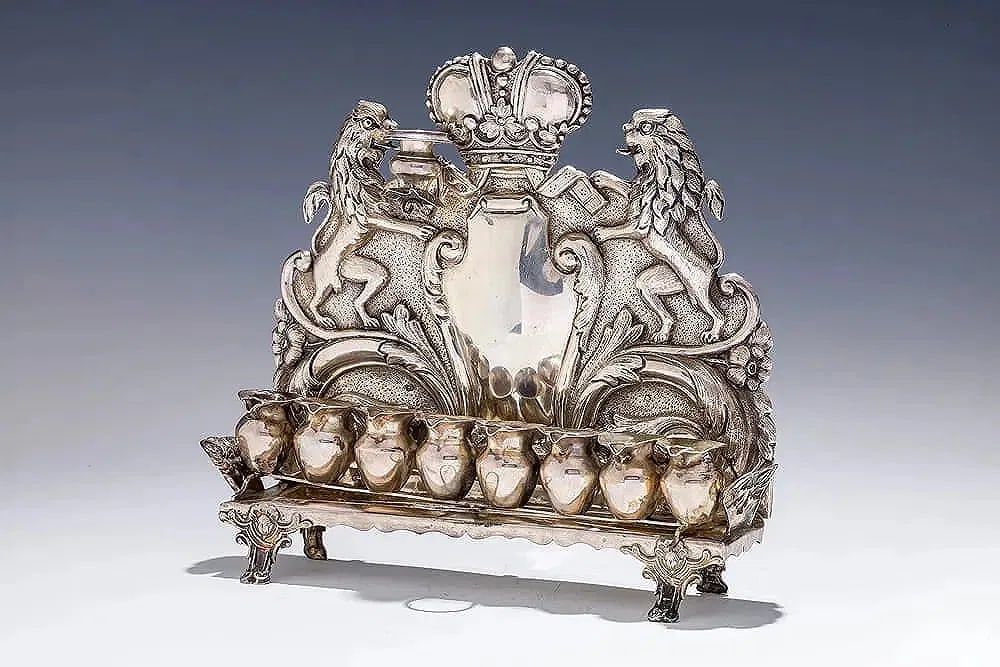 AN ANTIQUE SILVER HANUKKAH LAMP. Vienna, c. 1890. Austria, c.1880. On a rectangle base supported 