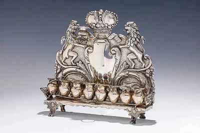 AN ANTIQUE SILVER HANUKKAH LAMP. Vienna, c. 1890. Austria, c.1880. On a rectangle base supported 
