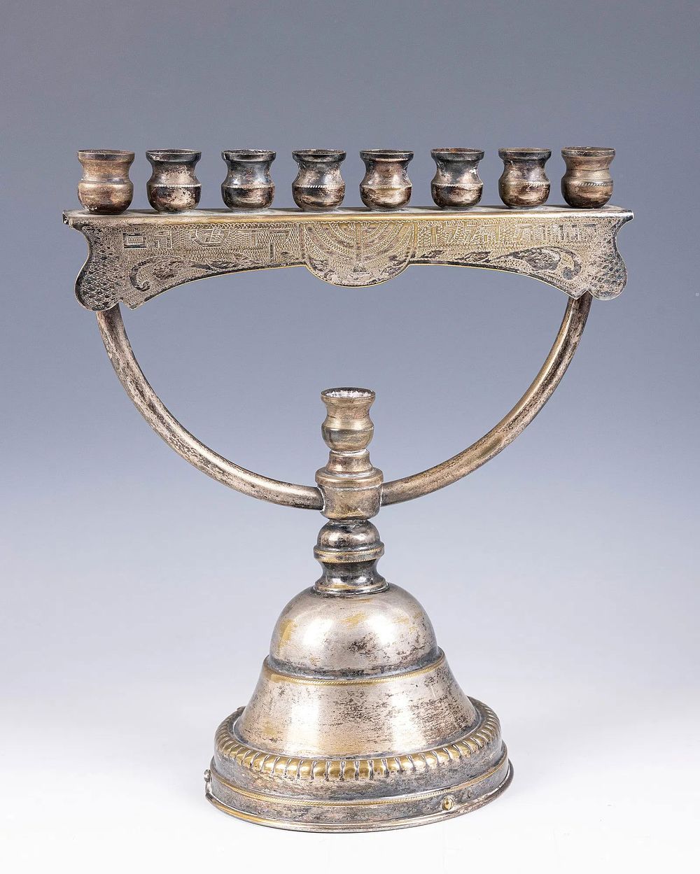 A LARGE SILVERPLATE MENORAH. Israel, c. 1960. On a round base with a non-working music box. 