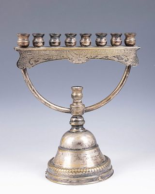 A LARGE SILVERPLATE MENORAH. Israel, c. 1960. On a round base with a non-working music box. 