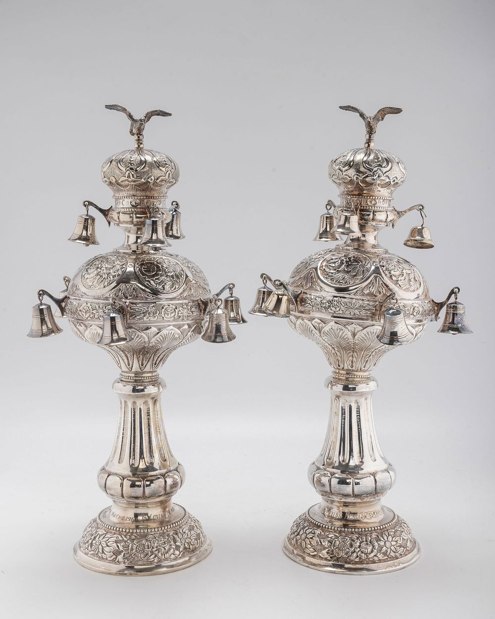 A PAIR OF LARGE SILVER TORAH FINIALS. Hungary, early 20th century. On round chased bases with 