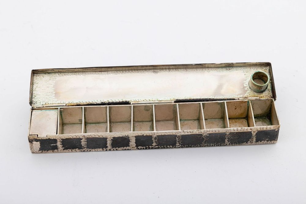 A STERLING SILVER TRAVELLING HANUKKAH LAMP. American, 20th century. Rectangular in form. 