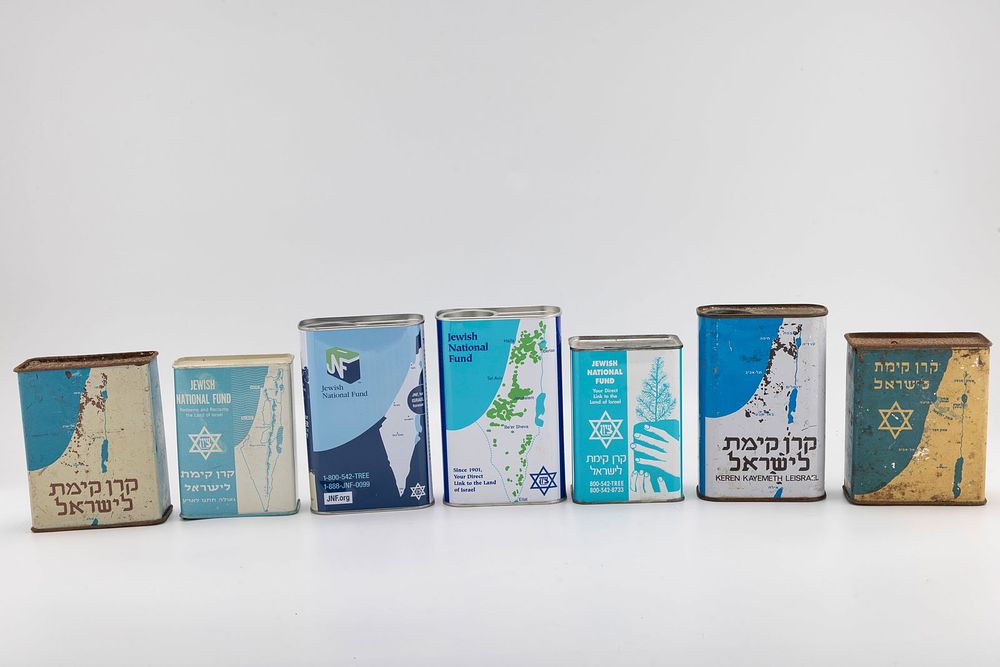 A COLLECTION OF SEVEN JNFCHARITY CONTAINERS. Spanning 1930 to modern times. Various countries.