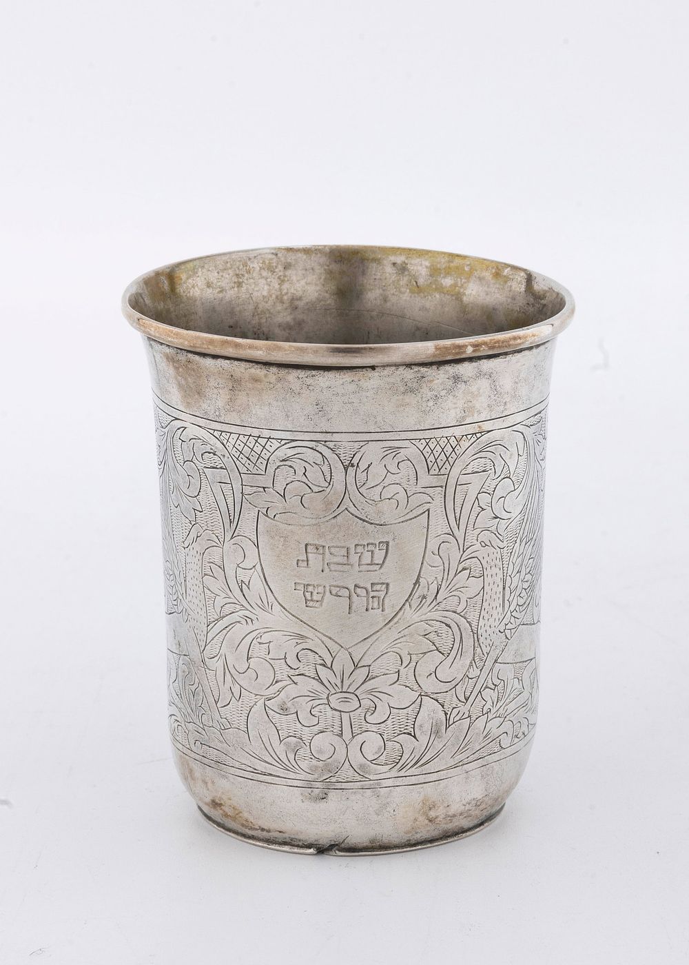 AN ANTIQUE SILVER KIDDUSH BEAKER. Poland, c. 1850. In traditional form. Engraved with two regal 