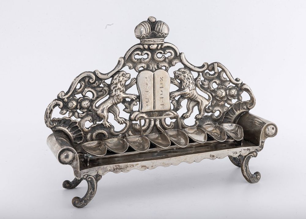 A SOFA SHAPED SILVER HANUKKAH LAMP. Vienna, Austria, 1842. The body is in the form of a sofa. 