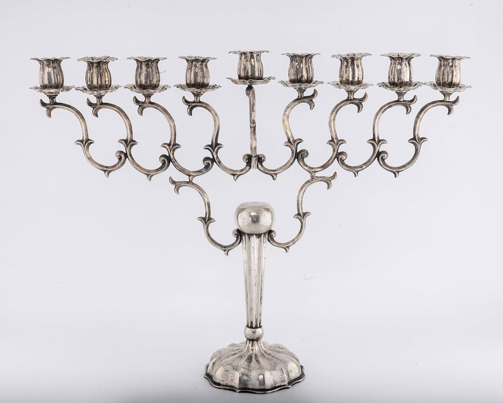 EXCEPTIONAL HAND WROUGHT SILVER MENORAH. Vienna, Austria, c. 1890. On a domed base with an 