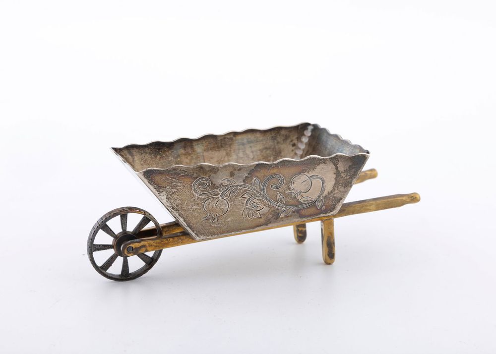 A STERLING SILVER CHAROSET CONTAINER BY SHUKI FREIMAN, JERUSALEM. In the shape of a wheelbarrow. 
