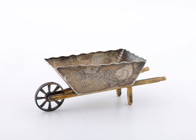 A STERLING SILVER CHAROSET CONTAINER BY SHUKI FREIMAN, JERUSALEM. In the shape of a wheelbarrow. 