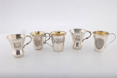 A GROUP OF FIVE "YELED TOV" STERLING SILVER CUPS. 2" or larger each. Minor dents. Total weight 