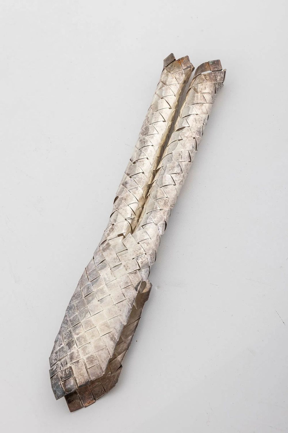 A STERLING SILVER LULAV HOLDER BY NETAFIM. Israel, C. 1990. Woven, like a regular lulav holder 