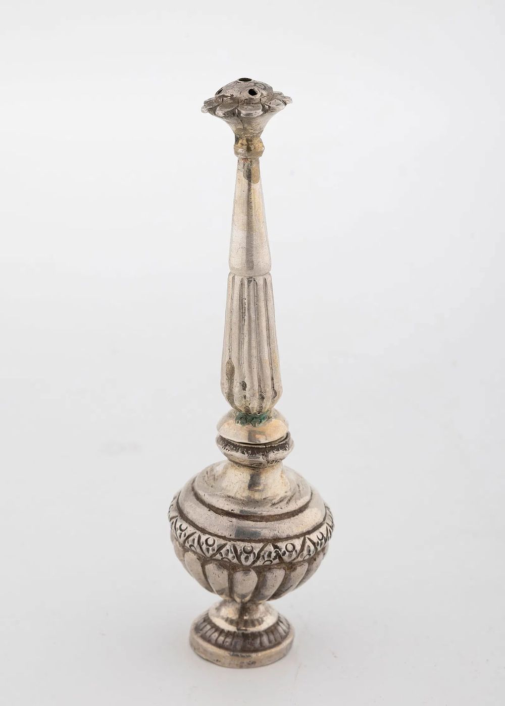 A SILVER ROSE WATER CONTAINER. Ottoman Empire, c. 1900. Traditional bottle form. 4.5" tall.