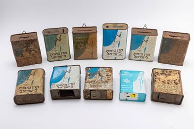 A GROUP OF 11 JEWISH NATIONAL FUND CHARITY CONTAINERS. Spanning 1920 - 1970. Various countries 