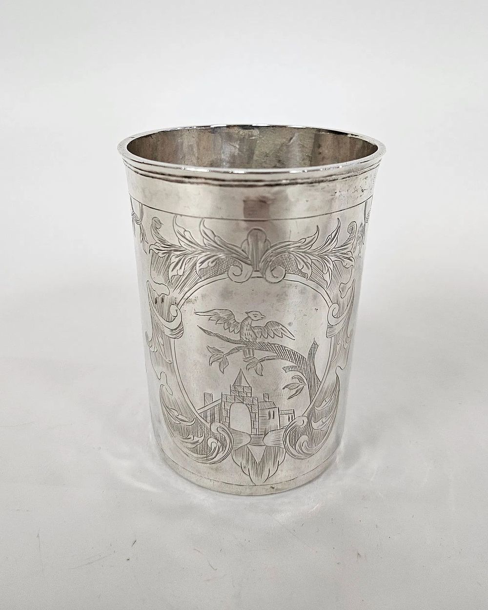AN ANTIQUE SILVER CUP. Russia, 1775. Beaker form. Engraved with town scenes, cartouches, and 