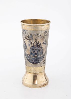 A PARCEL GILT AND NIELLO BEAKER. Russian, c. 1880. On a round base with scrolling niello designs 
