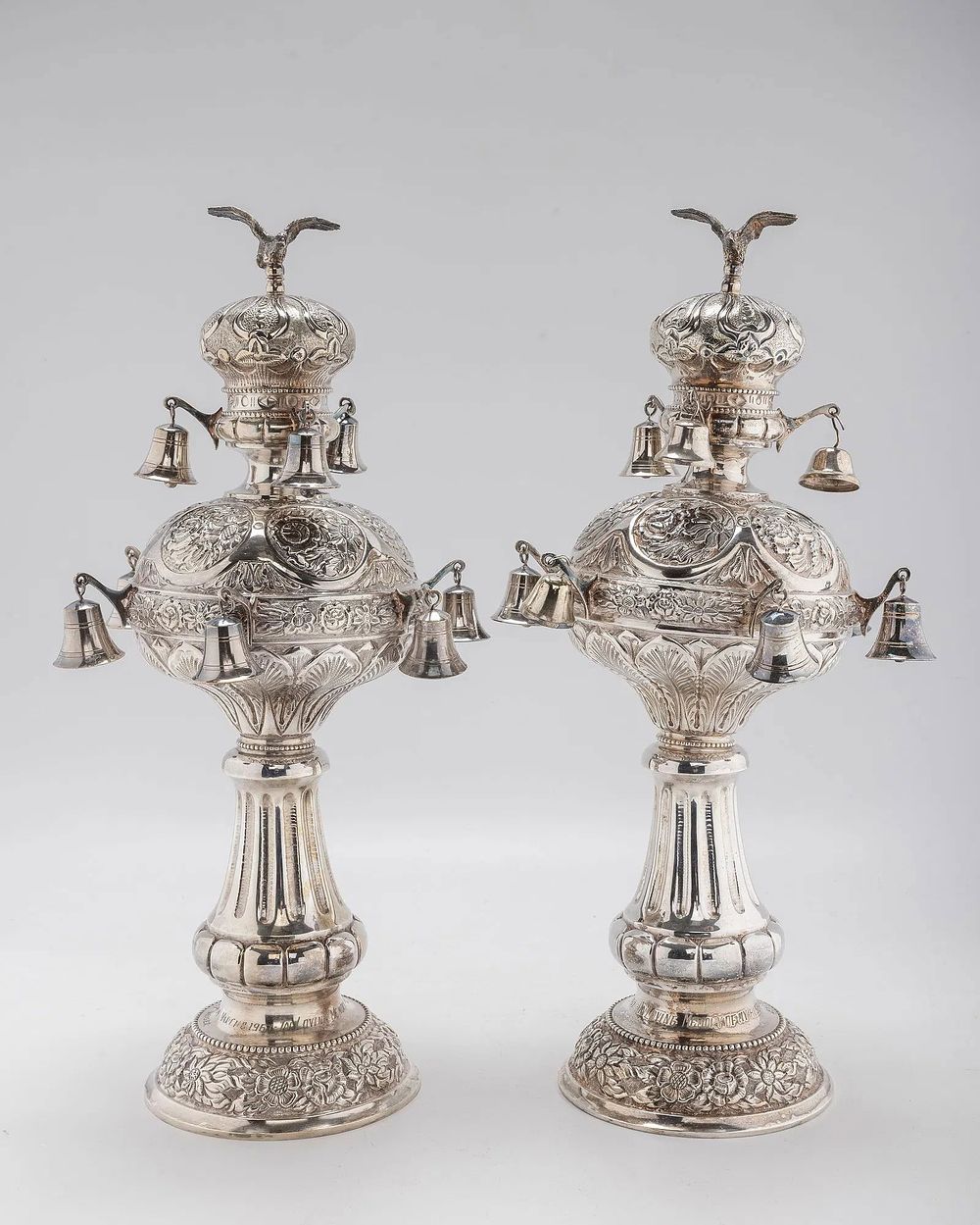 A PAIR OF LARGE SILVER TORAH FINIALS. Hungary, early 20th century. On round chased bases with 