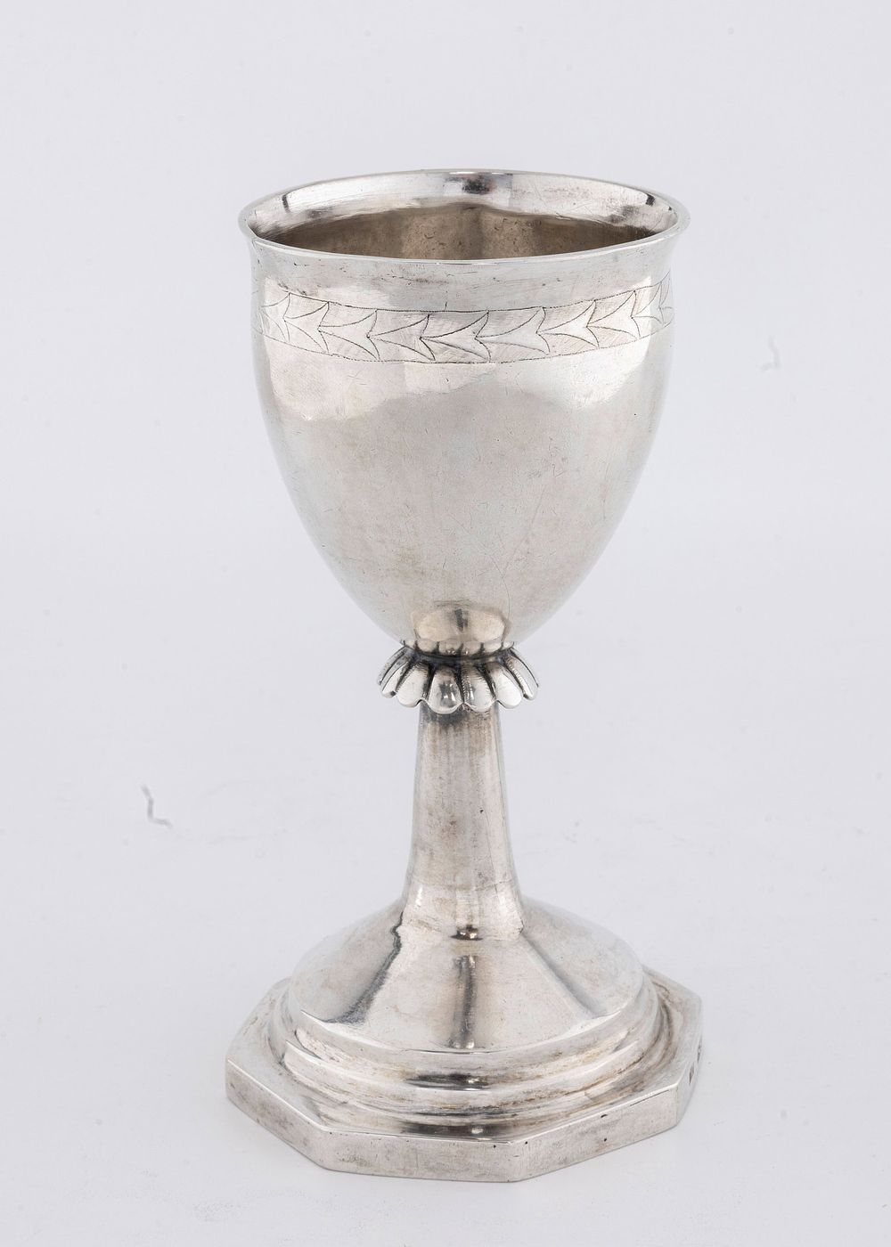 A LARGE SILVER KIDDUSH CUP. Poland, c. 1840. On an octagonal base with a skirted stem and an 