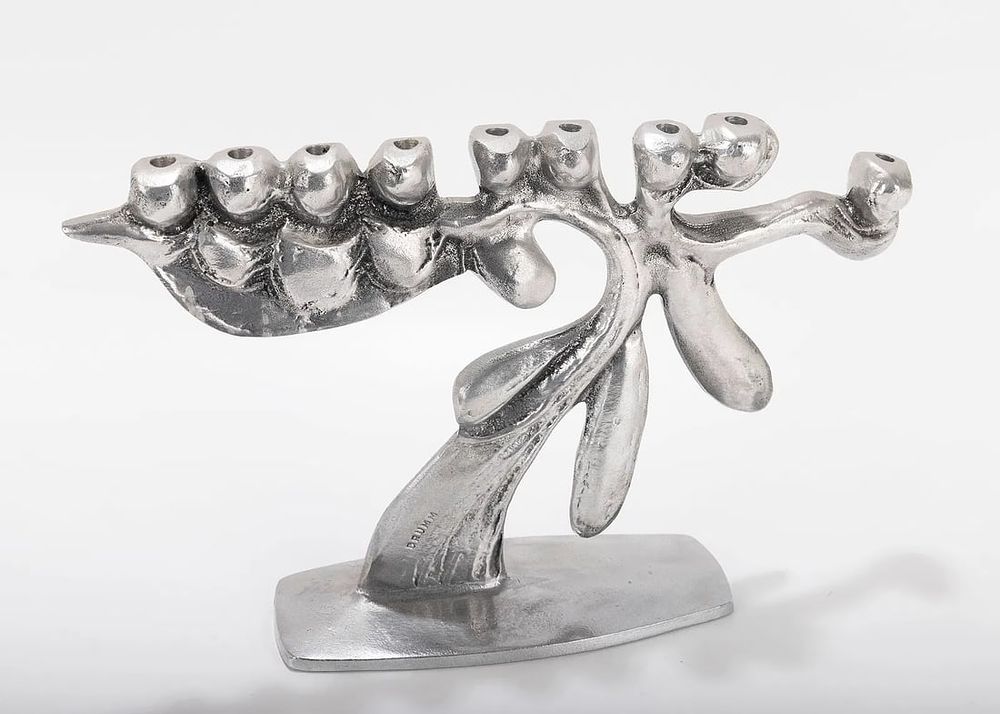 A LARGE ALUMINUM MENORAH SCULPTURE BY DON DRUMM (American, b. 1935). Abstract in design on 
