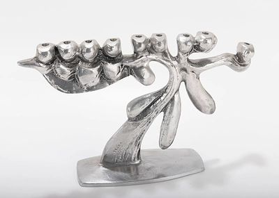 A LARGE ALUMINUM MENORAH SCULPTURE BY DON DRUMM (American, b. 1935). Abstract in design on 