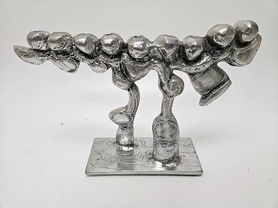 A LARGE ALUMINUM MENORAH SCULPTURE BY DON DRUMM (American, b. 1935). Abstract in design on 