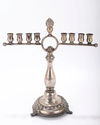 A SILVER HANUKKAH MENORAH. Germany, c. 1900. On a round base with a circular mount and eight 