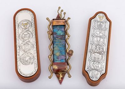 A GROUP OF THREE MEZUZAH CASES UNUSED. Composed of wood and white metal decorated with the seven 