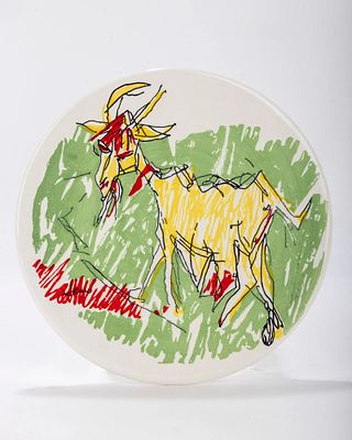 A CERAMIC PLATE BY MENASHE KADISHMAN. Israel c. 1990. Decorated with a ram. Signed. 12" wide.