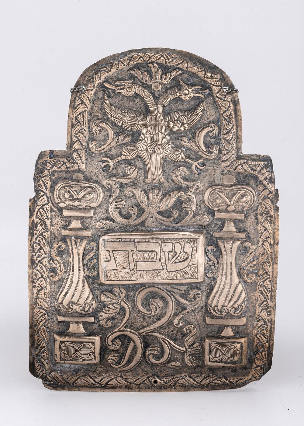 AN EARLY SILVER TORAH SHIELD. Poland, c. 1750. Embossed with a double headed eagel, scrolling 