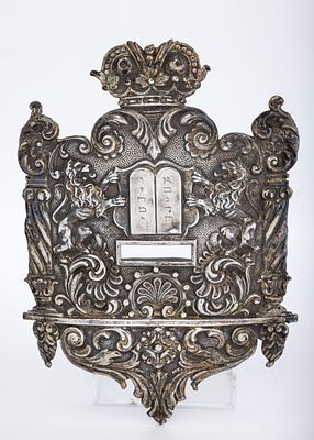 A SILVER TORAH SHIELD. Vienna, c. 1920. Traditional tablet form. Decorated with two lions 