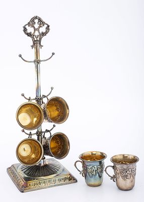 A SET OF SIX SMALL KIDDUSH CUPS. Israel, c. 2000. Six small kiddush beakers suspended from a 