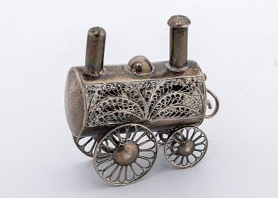 A SILVER SPICE CONTAINER IN THE SHAPE OF A LOCOMOTIVE. Poland, c. 1880. On four wheels with two 