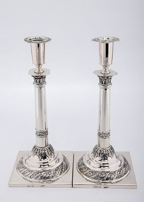 A PAIR OF SILVER SABBATH CANDLESTICKS BY LUDWIG NAST. Warsaw, 1882. On a square base with 