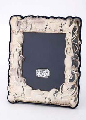 A STERLING SILVER PICTURE FRAME. London, 1995. Decorated with embossed designs of a train , a 