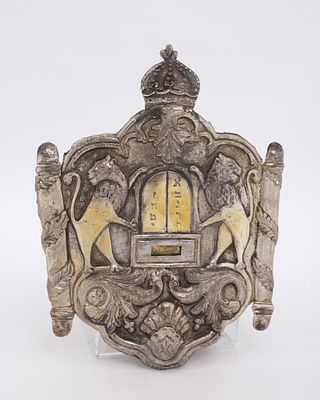 A SILVER TORAH SHIELD. Probably Romania, c. 1880. Hand chased with two outwardly facing lions 
