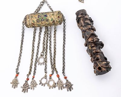 AN AMULET HOLDER AND A MEZUZAH CASE. The amulet holder is tubular and decorated with applied 