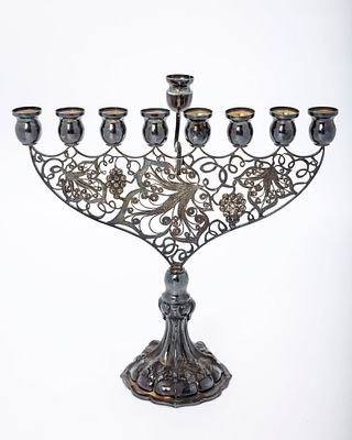 A STERLING SILVER HANUKKAH MENORAH. Israel, c. 2000. On a stylized round base with a filigree 