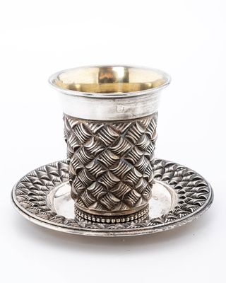 A STERLING SILVER KIDDUSH CUP AND PLATE. Israel, c. 2000. In a basket weave design. The cup is 