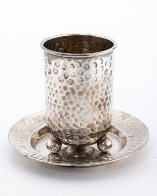 A STERLING SILVER KIDDUSH CUP AND PLATE. Israel, c. 2000. In hand hammered design. The cup is 