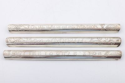 THREE STERLING SILVER JUDAIC CRUMB SWEEPERS. Each engraved with a different Hebrew bread 
