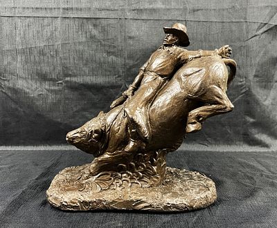 Rodeo Bull Riding Cowboy Sculpture depicting a large rough stock bull trying to buck the rider