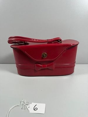 A Vintage-Style Red Bag- 4.5" tall. A vintage-style, hard-sided bag, presenting in a glossy 