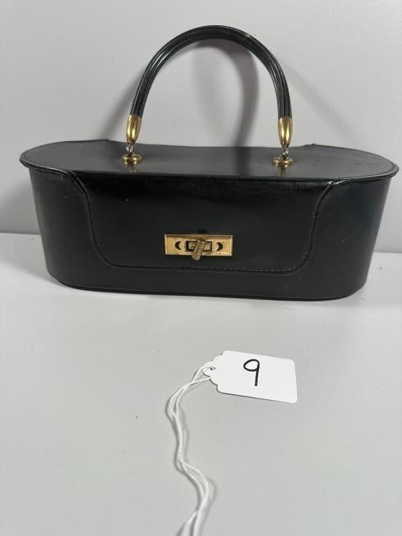 A Vintage-Style Black Hard-Sided Vanity Case or Ha. An elongated oval form vanity case or 