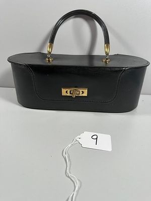 A Vintage-Style Black Hard-Sided Vanity Case or Ha. An elongated oval form vanity case or 