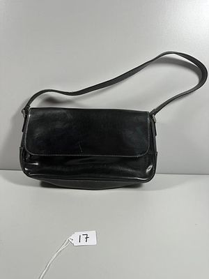 A Liz Claiborne Faux Leather Flap Front Shoulder Bag. This black women's shoulder bag is styled 