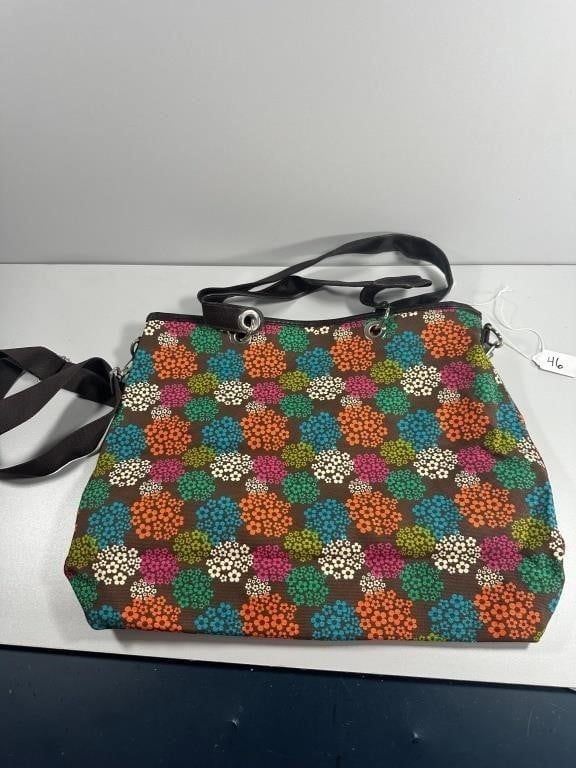 Fabric Tote Bag. A fabric tote bag, featuring a vibrant, multicolored floral pattern of 