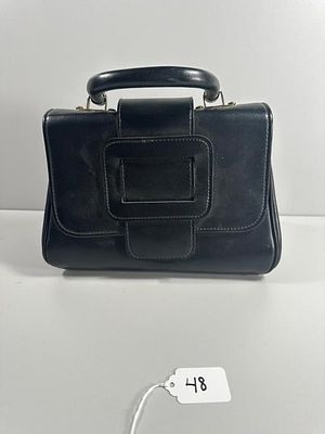 A Vintage-Style Black Top-Handle Handbag. A structured, black top-handle handbag, exhibiting a 