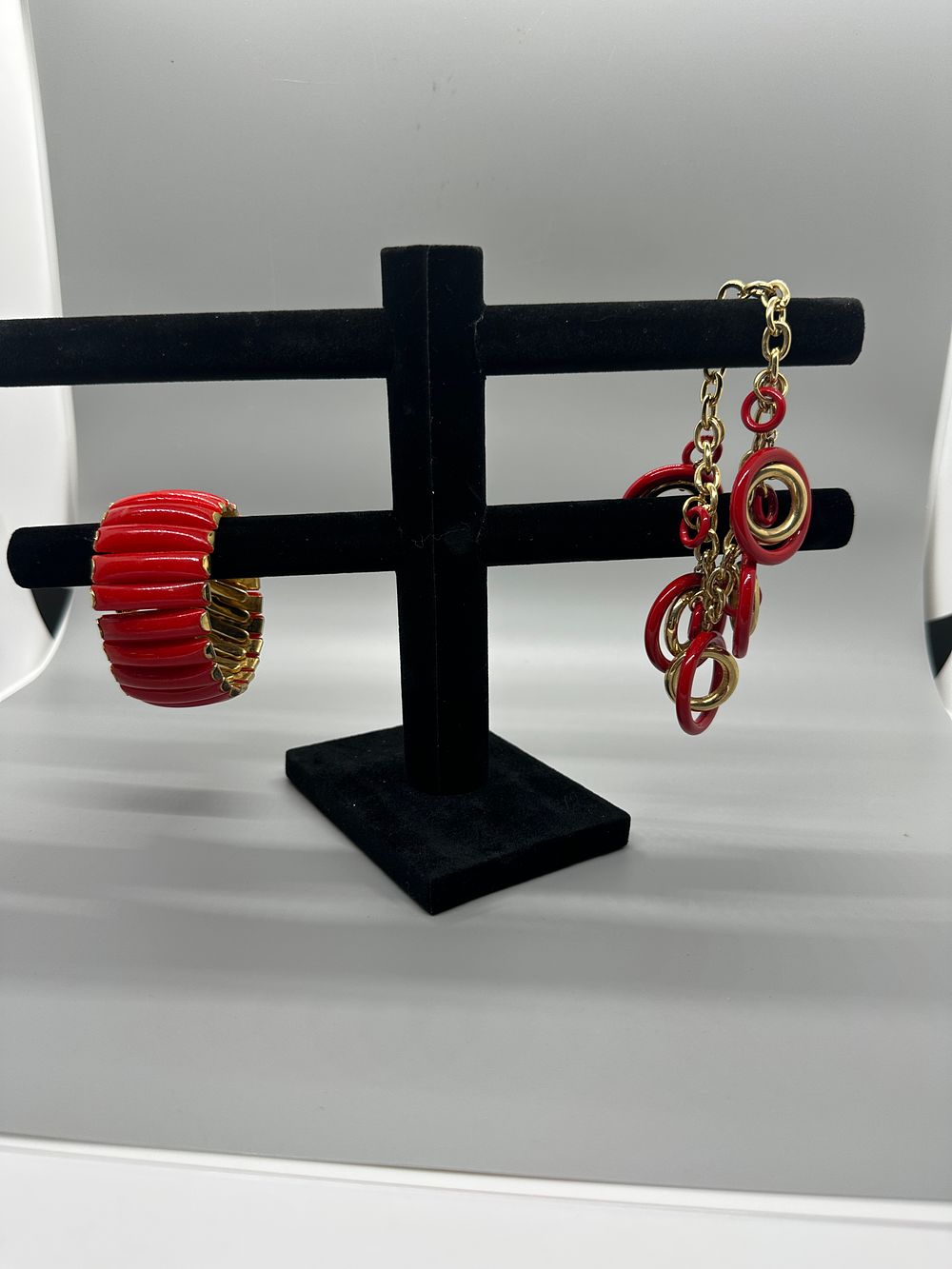 A Collection of Red and Gold Tone Jewelry. A collection of red and gold-tone jewelry featuring a 